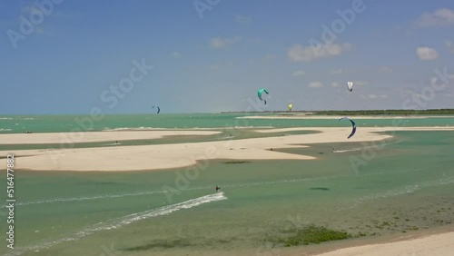 Brazilian kite surfer in high speed jumping with several kites in background