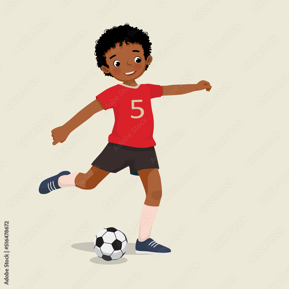 cute little African boy playing soccer kicking the football to make a goal