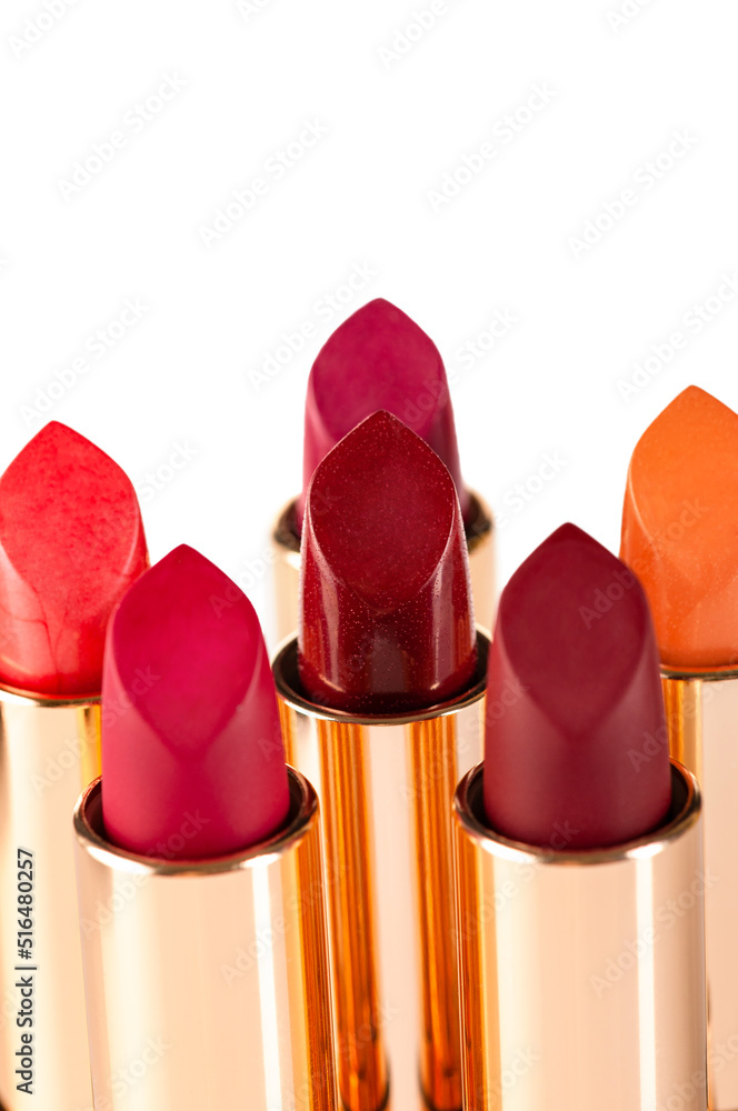 Different colors of lipstick on a white background. Decorative cosmetics. Different colors of lipstick on a white background. Decorative cosmetics.