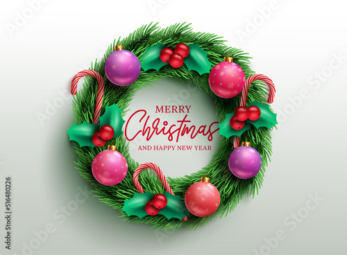 Christmas wreath vector concept design. Merry christmas greeting text in wreath decoration with holly berry, balls and candy cane for xmas holiday celebration. Vector illustration.
