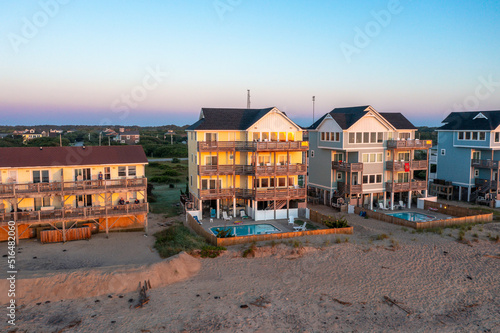 Photo Aerial view of beach homes with pools during sunrise for rent in Buxton North Ca
