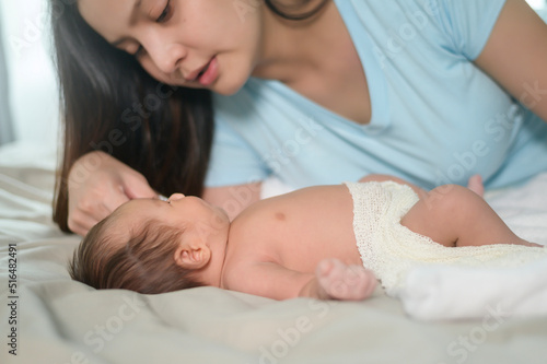 Young mother with a Cute new born baby.