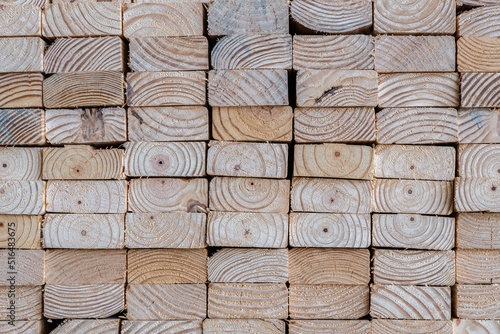 Photograph of the end profile of a stack of 2 x 4 studs in a lumber yard featuring the wood grain photo