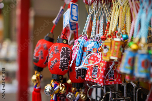 Close up of collection of colorful souvenirs hanged at a shop at Nakamise dori street in Sensoji Temple with bokeh background. No people.