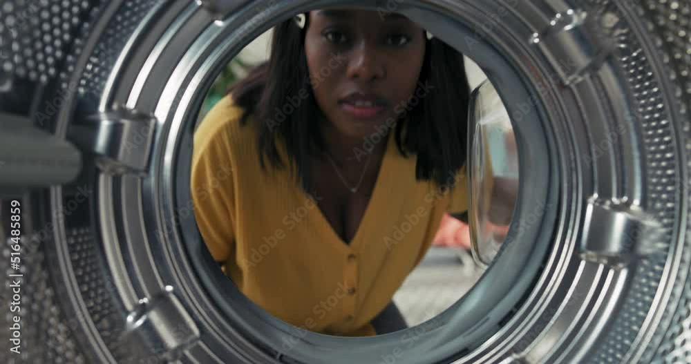View from inside the drum, a woman looks inside the washing machine that needs to be cleaned washed, the girl makes a wry face covers her nose, unpleasant smell. View from inside the drum, a woman looks inside the washing machine that needs to be cleaned washed, the girl makes a wry face covers her nose, unpleasant smell.