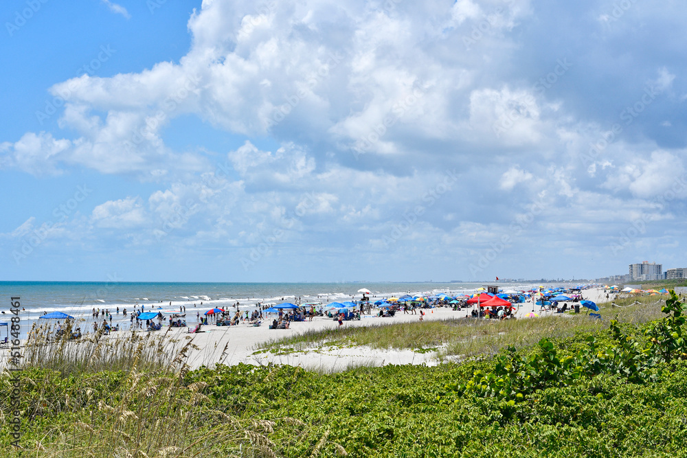Fototapeta premium Cocoa Beach crowded with tourists and locals in summer on the space coast in Central Florida, Brevard county. 
