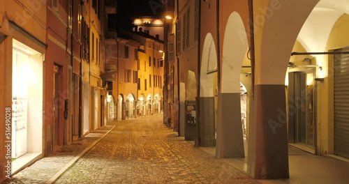 Shot of empty historic street near main square due to covid restrictions at night in Cesena, Northern Italy.