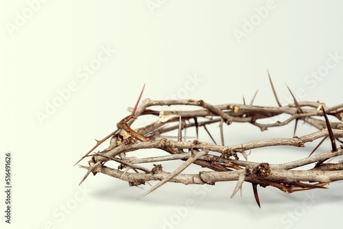 Crown of thorns symbolizing the sacrifice, suffering and resurrection of Jesus Christ on the cross on light background