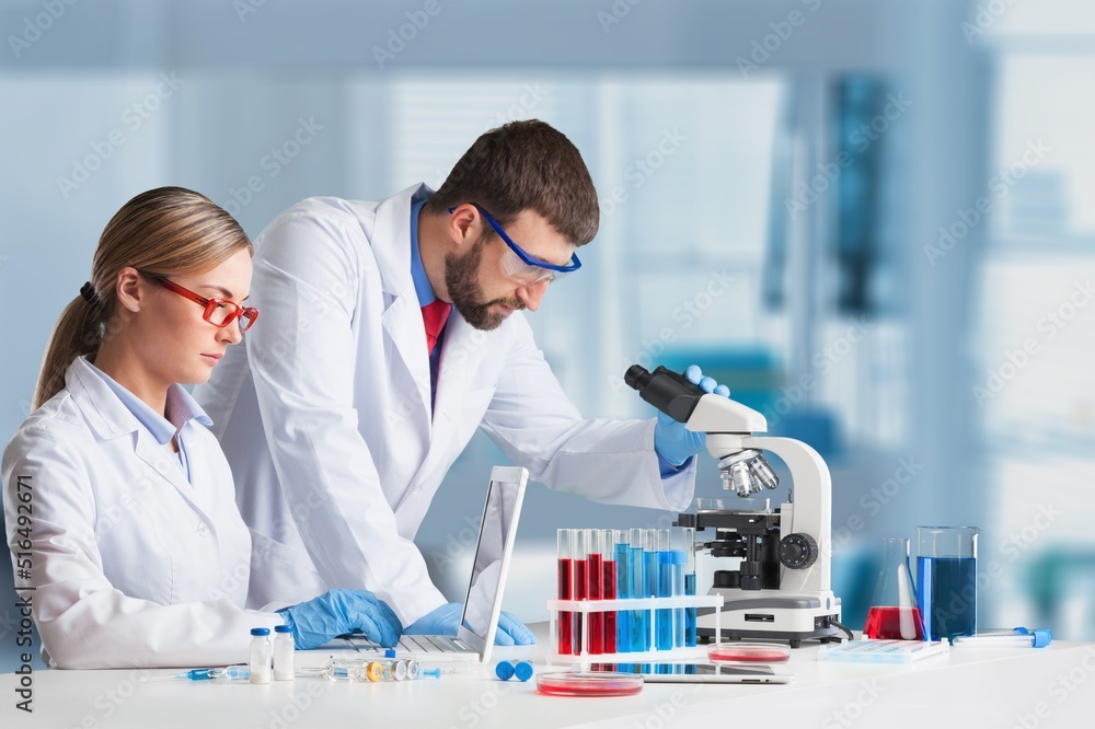Students working in the clinical laboratory, a researcher is using a microscope, scientific research concept Students working in the clinical laboratory, a researcher is using a microscope, scientific research concept