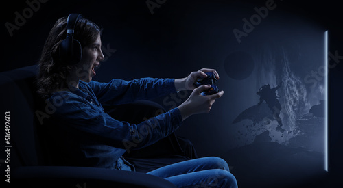 A woman in headphones with a controller set aside in her hands