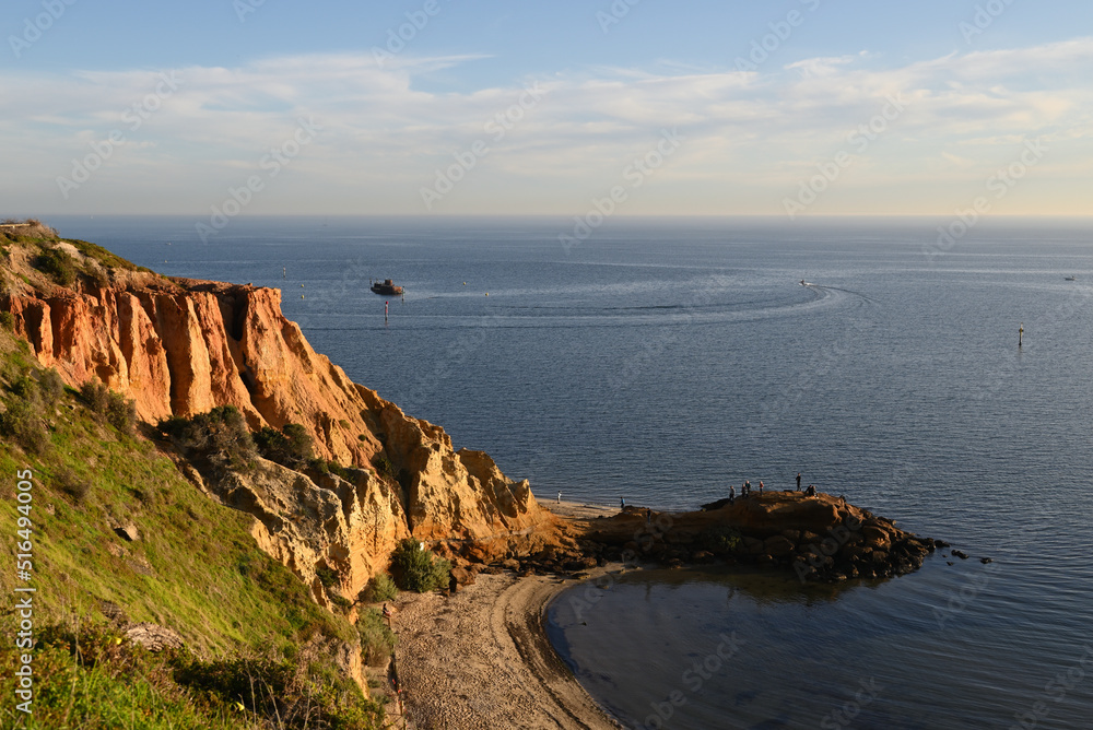 Popular natural landmark Red Bluff, located in one of eastern Melbourne's coastal suburbs, with the HMVS Cerberus shipwreck in the background