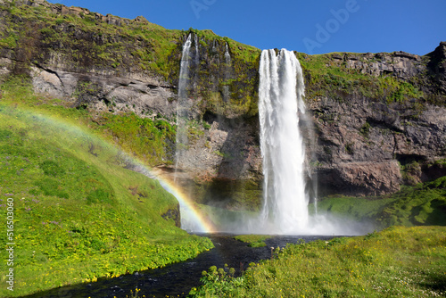 Beautiful Seljalandsfoss waterfall and rainbow in Iceland, icelandic summer nature and river landscape 