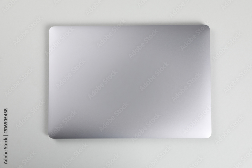 Blank close laptop on white table, top view Blank close laptop on white table, top view