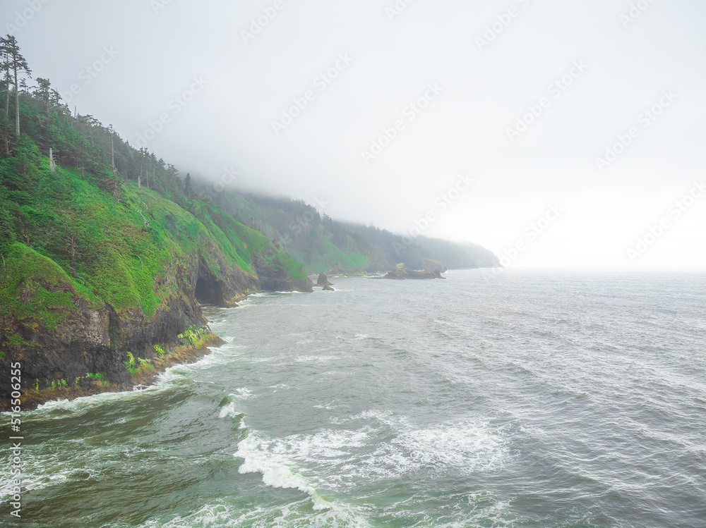Green hilly ocean shore. Light waves crash on the sandy shore. Beautiful landscape. Advertising of tourist destinations, tourism, travel, ecology, geology, weather. Green hilly ocean shore. Light waves crash on the sandy shore. Beautiful landscape. Advertising of tourist destinations, tourism, travel, ecology, geology, weather.