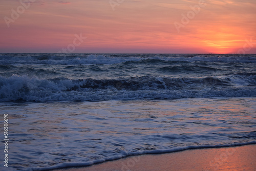 A beautiful sunset on the beach in the turbulent ocean