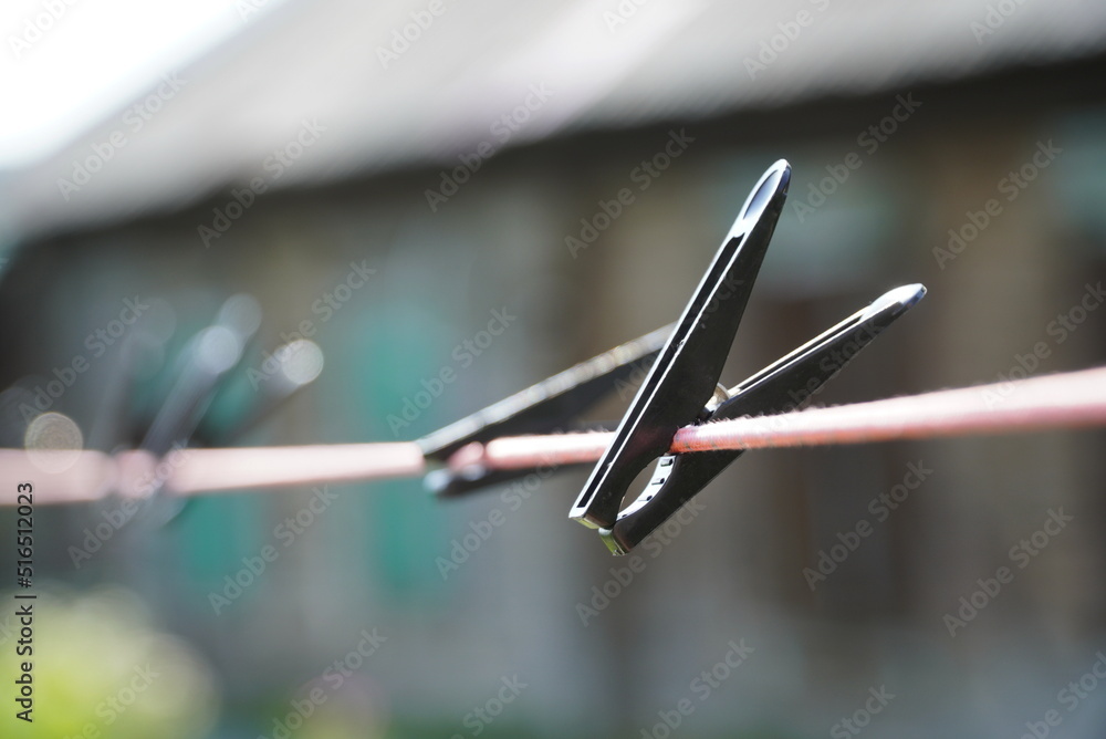 plastic black clothes pin on rope. Black Plastic Clothespins on a Clothesline for Drying Clothes plastic black clothes pin on rope. Black Plastic Clothespins on a Clothesline for Drying Clothes