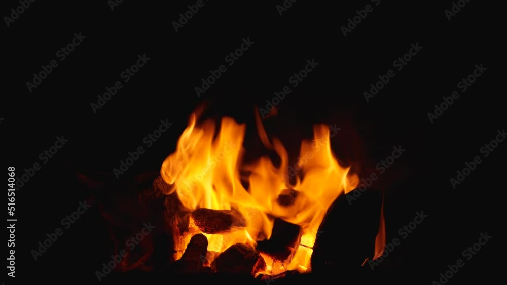 Close-up of the wood burning in the fire. A campfire at night during a trip Close-up of the wood burning in the fire. A campfire at night during a trip