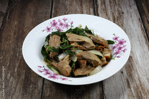 Traditional spicy duck meat mixed with basil and onion serving on the plate. Famous menu in Chinese restaurant.