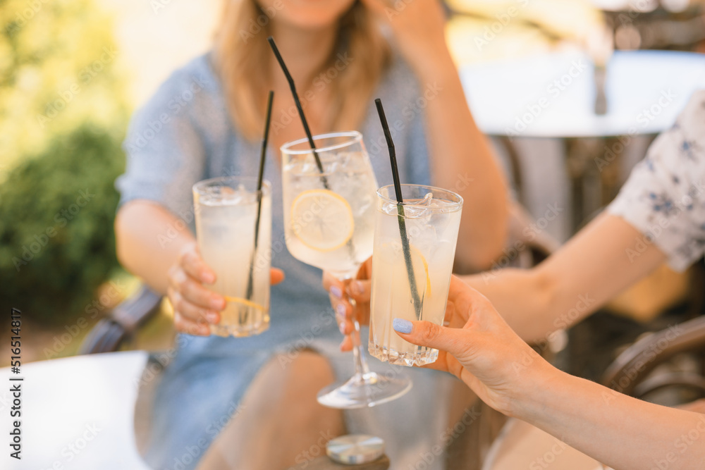 Friends having lemonade drinks on outdoors terrace. Summer lifestyle. Friends having lemonade drinks on outdoors terrace. Summer lifestyle.