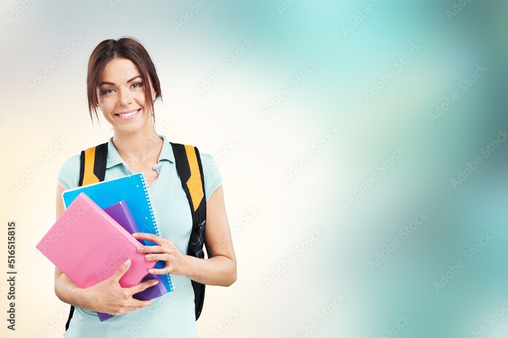 Young student woman wearing backpack and holding books Young student woman wearing backpack and holding books