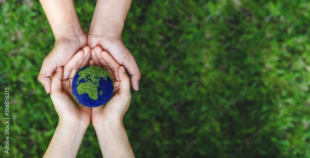 Many hands person holding the earth on a green background to protect nature Save and care World for sustainable. concept of the environment ecology and Earth Day - obrazy, fototapety, plakaty 