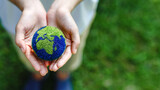 Hands holding the earth on a green background to protect nature Save and care World for sustainable. concept of the environment ecology and Earth Day