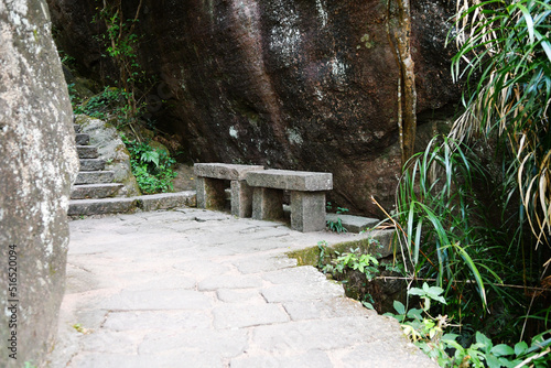 Fototapeta Naklejka Na Ścianę i Meble -  two stone seats beside the path in the mountains