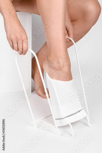 Anti-embolic Compression Hosiery for surgery isolated on white. Medical white stockings, tights for varicose veins and venouse therapy. Thrombo embolic deterrent hose or anti-embolism stockings. photo