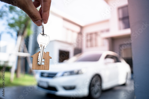 Selling home ,Landlord and New home. The house key for unlocking a new house is plugged into the door. Mortgage, rent, buy, sell, move home concept