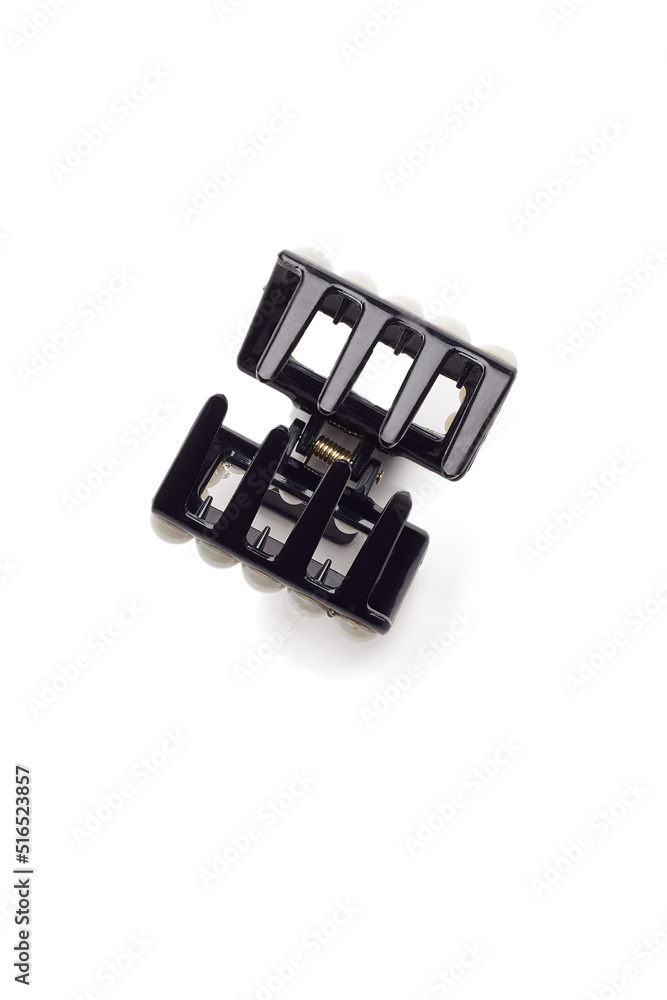Subject shot of a black hair clip decorated with pearls. The open hair clip is isolated on the white background. Vogue accessory for ladies and girls. Subject shot of a black hair clip decorated with pearls. The open hair clip is isolated on the white background. Vogue accessory for ladies and girls.