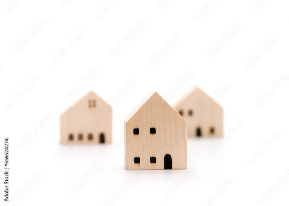 Property investment. Residential development. Real estate price. House valuation. Wooden house models on white background with copy space. Property investment. Residential development. Real estate price. House valuation. Wooden house models on white background with copy space.