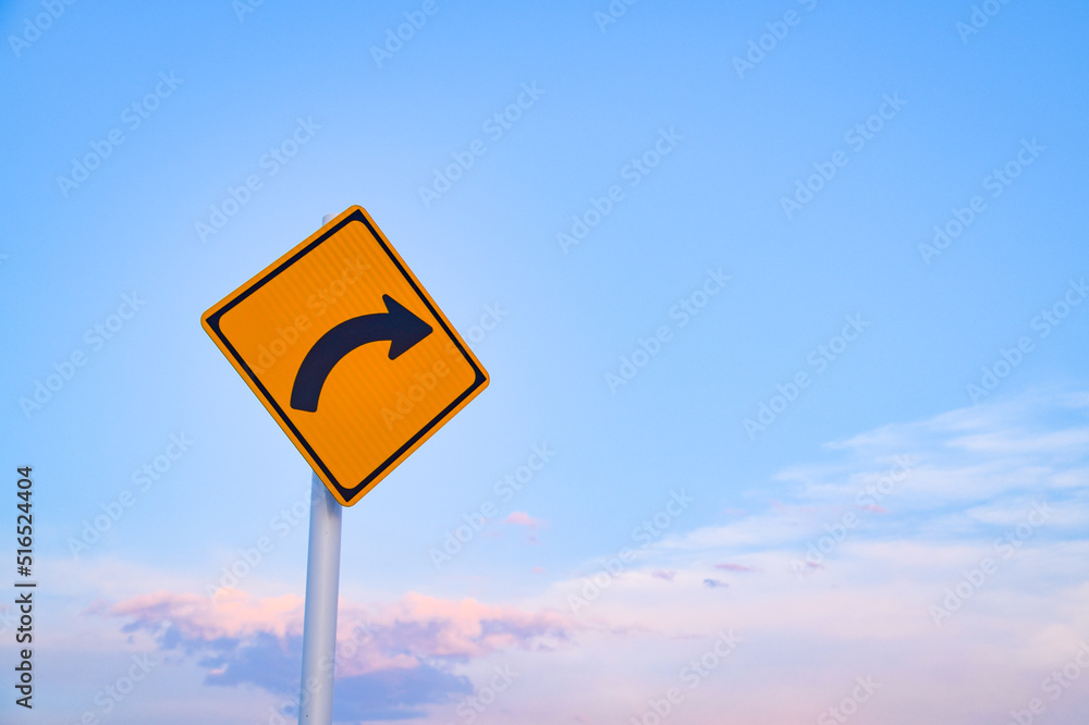 Curve caution road sign standing in the sky Curve caution road sign standing in the sky