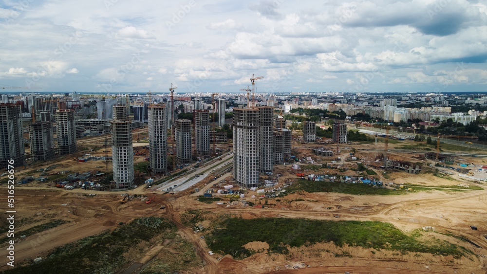 Construction site. Construction of multi-storey buildings. Construction of a city block. Aerial photography.