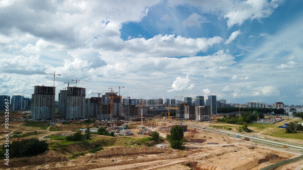 Construction site. Construction of multi-storey buildings. Construction of a city block. Aerial photography.