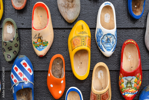 Koog aan de Zaan, Netherlands. July 2022. Colorful clogs against the background of a wooden wall. Popular souvenirs. Traditions of Holland. photo