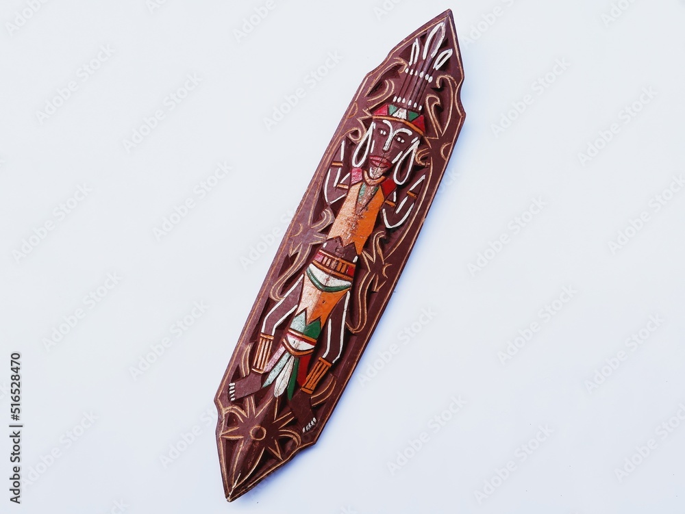Tameng. Tameng is Indonesian traditional shield Dayak tribe made from wood or iron with traditional carving. Isolated on white Tameng. Tameng is Indonesian traditional shield Dayak tribe made from wood or iron with traditional carving. Isolated on white