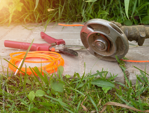 petrol lawnmowers.professional manual lawnmower Disc blade for trimmer,line and disc replacement tools close-up on tile