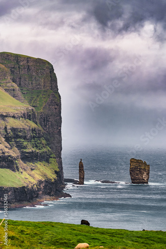 Risin og Kellingin rock formations on the coast of Eysturoy Island. Coastline high cliffs landscape. Eidi, Faroe Islands photo