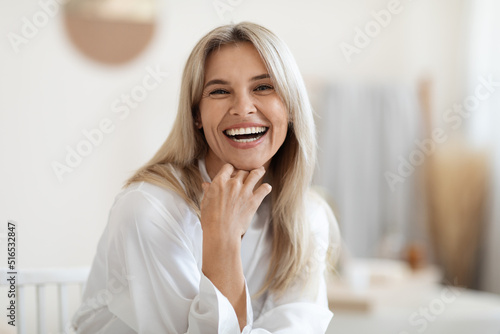 Fotografija Portrait of laughing beautiful woman touching her face