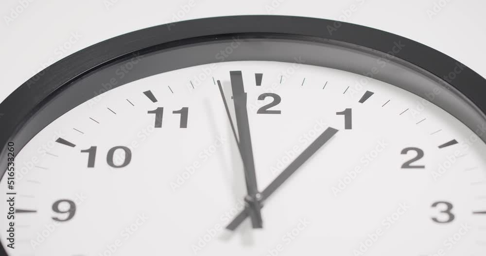 Close-up detail - Wall clock isolated show time 12.59 on white background.