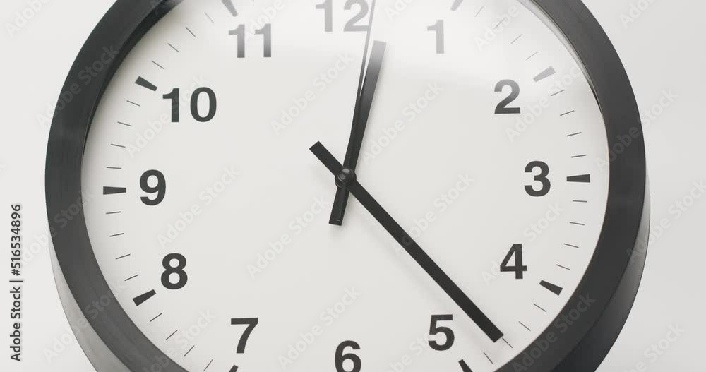 Close-up detail - Wall clock isolated show time 12.23 on white background. Close-up detail - Wall clock isolated show time 12.23 on white background.