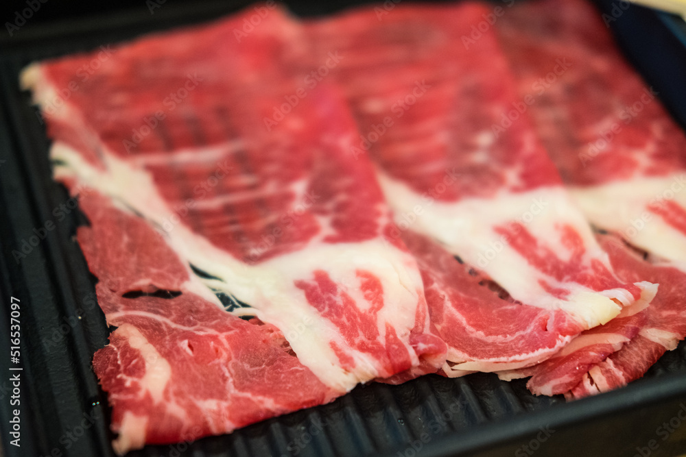 Fresh beef raw sliced with marbled texture served for Sukiyaki. Fresh beef raw sliced with marbled texture served for Sukiyaki.