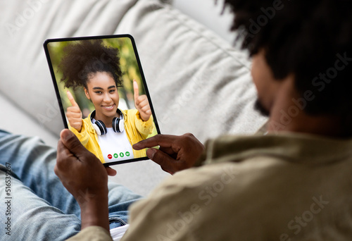 Young Black Man Using Digital Tablet For Video Call At Home