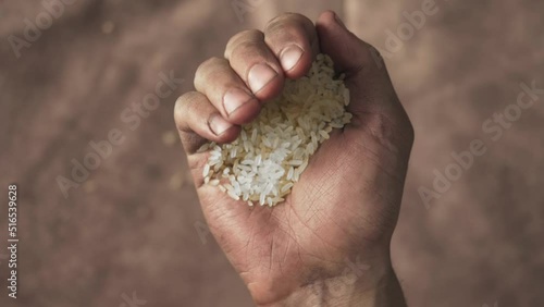 rice in dirty male hands, hunger and poverty concepts. conflict as a cause of hunger. world hunger problem, food shortages and waste, climate change, drought, loss of harvest, war and conflict photo