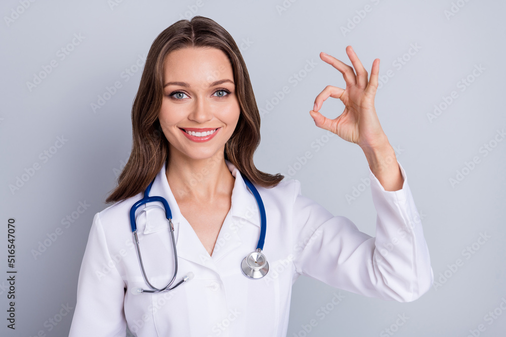 Photo of scientist lady invent hight quality covid protection vaccine show okay symbol isolated grey color background Photo of scientist lady invent hight quality covid protection vaccine show okay symbol isolated grey color background