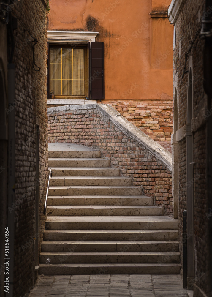 View of bridge and street from an alley in Venice, Italy 