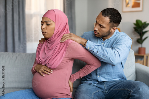 Loving husband making massage to his pregnant black muslim wife at home © Prostock-studio