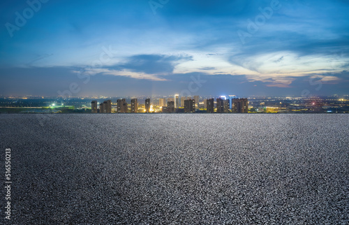 Asphalt road and modern city skyline with building scenery at night. high angle view. © ABCDstock