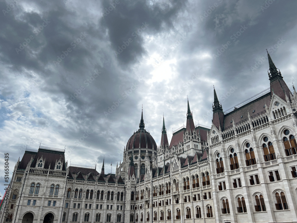 Marble building of the Hungarian Parliament against a cloudy sky