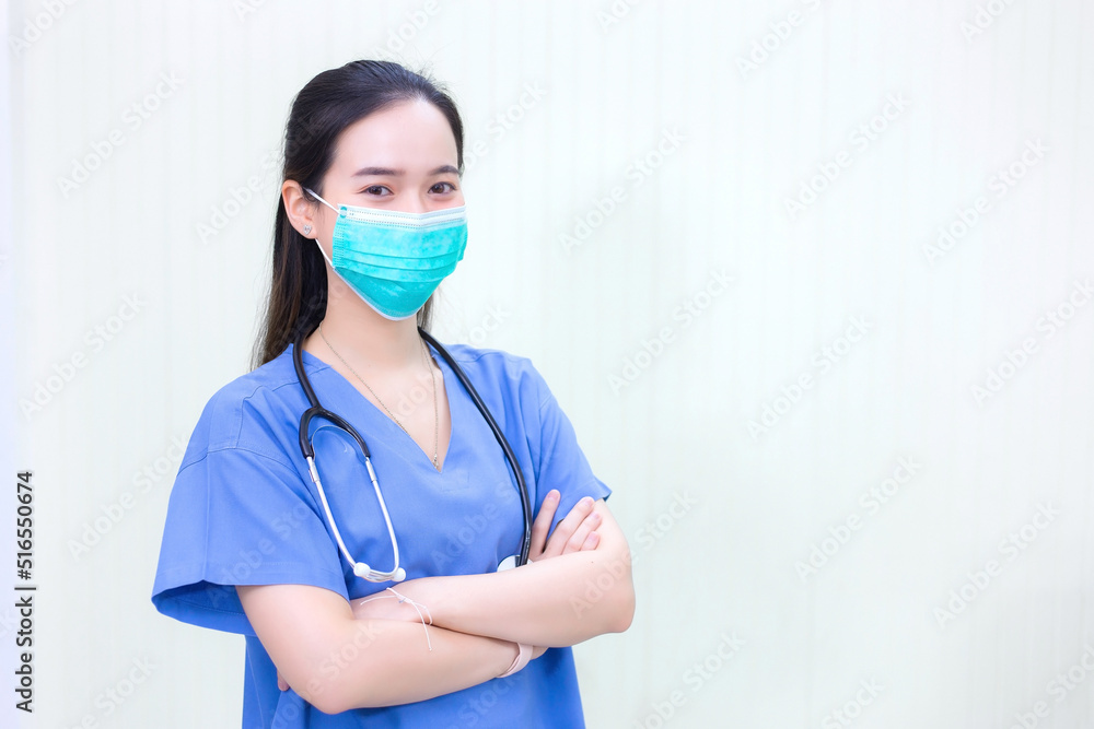 Asian doctor wears a medical coat with stethoscope and medical face mask to protect respiratory system from pathogen in new normal concept. Asian doctor wears a medical coat with stethoscope and medical face mask to protect respiratory system from pathogen in new normal concept.